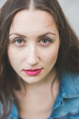 Portrait of a young beautiful millennial green eyes woman looking in camera