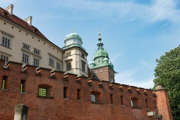 Fototapeta na wymiar Wavel royal castle with brick walls in Krakow, Poland against a blue sky