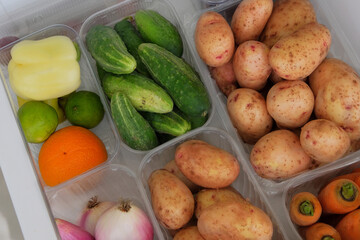 Various vegetables in containers in fridge. Gastronomy for cooking. Top view.