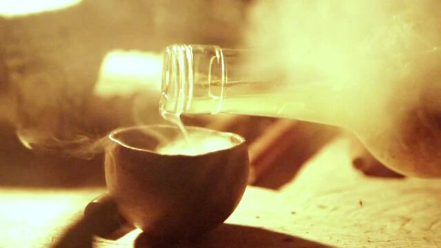 Closeup footage of the pouring of medical liquid in a pot, South African shaman medicine