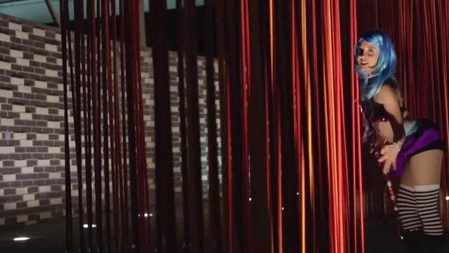 Regular footage of a hula hoop performer woman in an underground