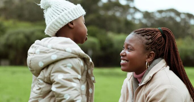 Talking, love and mom and child in park for conversation, laughing and having fun bonding together. Nature, smile and African young mother playing with girl kid in outdoor garden for family adventure