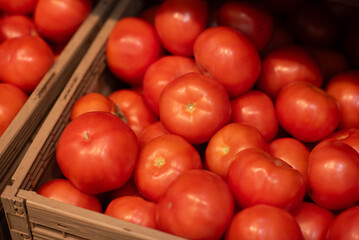 Tomatoes in a grocery store. Background with selective focus. Eco product.