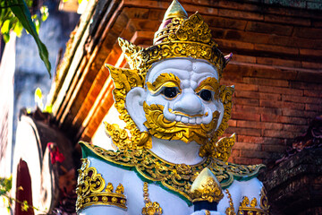 Portrait of a Yak Giant Demon / Protector statue : outdoor statue under a tree at the entrance of temple at Wat Inthakhin Sadue Muang in Chiang Mai