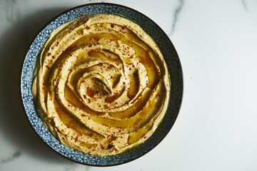 Turkish hummus close up. Creamy dip made from chickpeas, tahini, olive oil, lemon juice, and garlic. Include yogurt or butter for extra richness. 