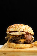 Delicious cheeseburger and french fries displayed on a cutting board.