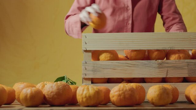 Put oranges in fruit crate