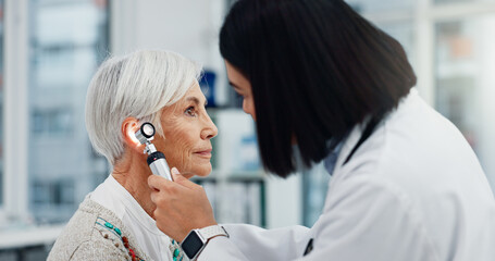 Senior woman, doctor and otoscope for ear, hearing test and exam, audio check or consultation for...