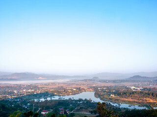 Fototapeta premium Natural viewpoint, mountains, hills, forests and river under morning mist in Chiangrai, Thailand