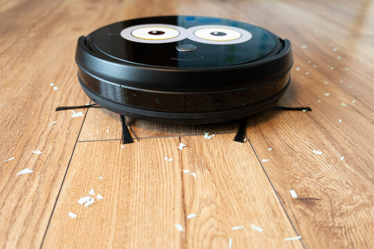 Robotic vacuum cleaner on wood floor smart cleaning technology.