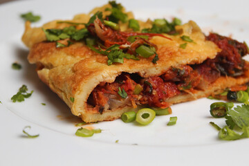 Close view of A piece of Egg omelet  into the white plate. 