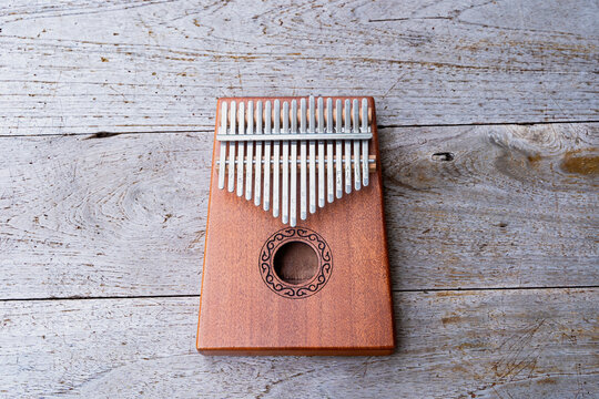 Overhead photo of mbira instrument with copy space. Wooden kalimba on the wooden background. Kalimba, acoustic music instrument from africa at wooden Background