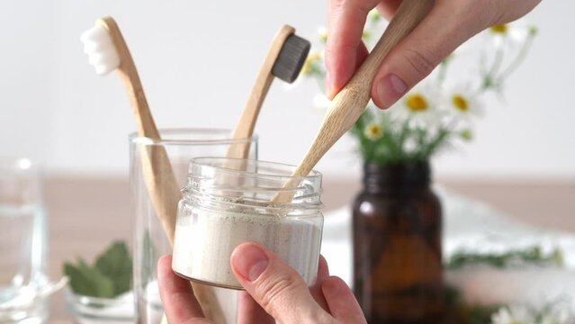 Craft tooth powder on a bamboo zcb brush close-up. Baboo toothbrushes, plants, natural cosmetics - conscious consumption and love for the body. Taking care of yourself and the environment.