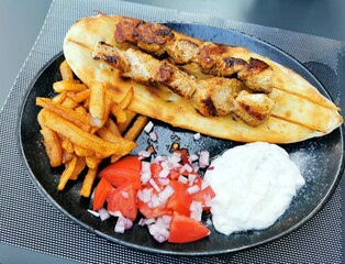 Souvlaki.  Popular Greek fast food consisting of small pieces of meat and sometimes vegetables grilled on a skewer. 