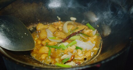 Close up cooking Thai food Stir fried Chicken with cashew nuts in frying pan at the kitchen restaurant