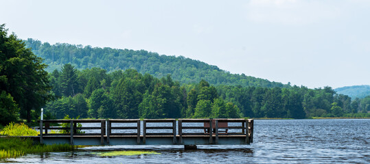 A walking pier jutting into the lake at Chapman State Park on a sunny summer day