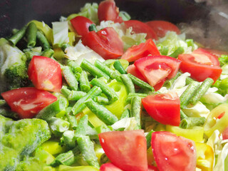 sliced green beans, yellow pepper and red tomato for vegetarian background
