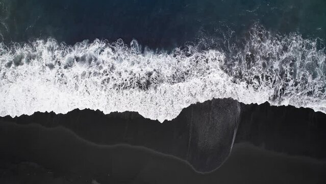 Black volcanic rock beach at Bali with White Ocean Waves drone DJI Mavic bird eye view top down