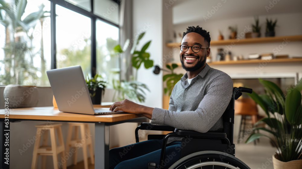 Canvas Prints Middle-aged man in a wheelchair works from his home office.