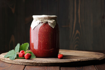 Strawberry jam in glass can with fresh berry and leaf on wood and rustic background, cottagecore aesthetic, copy space, batch cooking, sustainable living, zero waste storage concept - obrazy, fototapety, plakaty
