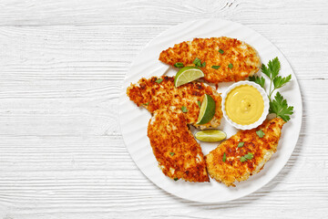 fried chicken cutlets on white plate, top view