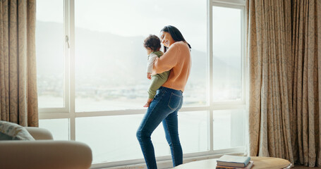 Care, happy and a mother with a baby in a house and looking at the view from a window. Smile, hug...