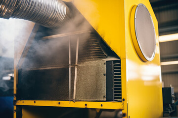Detailed shot of a sizable fume extractor in a welding shop that is removing dangerous fumes with a number of filters.