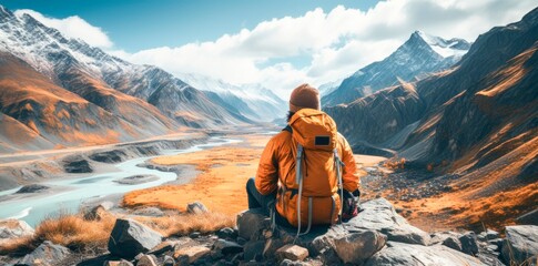 a man with backpack taking a view in the mountains
