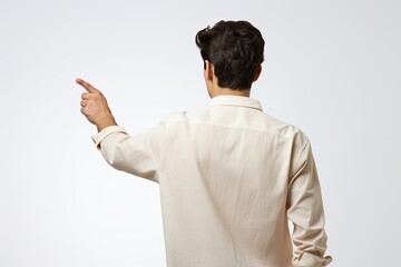 View from the back of a man in a white shirt points his finger to the side on a white background.