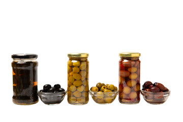 Delicious black, green and red olives in a jar isolated on a white background. Pickled olives in a glass jar. Delicious olives. Close-up. Vegan.Collage. Design.