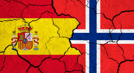 Flags of Spain and Norway on cracked surface - politics, relationship concept