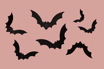 Paper bats for Halloween party on pink background
