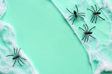 Cobweb with spiders for Halloween party on turquoise background
