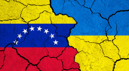 Flags of Venezuela and Ukraine on cracked surface - politics, relationship concept