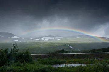 Fototapete Rund Amazing rainbow in cloudy sky over the tundra landscape on the Arctic Circle line in northern  Norway © Stefano Zaccaria