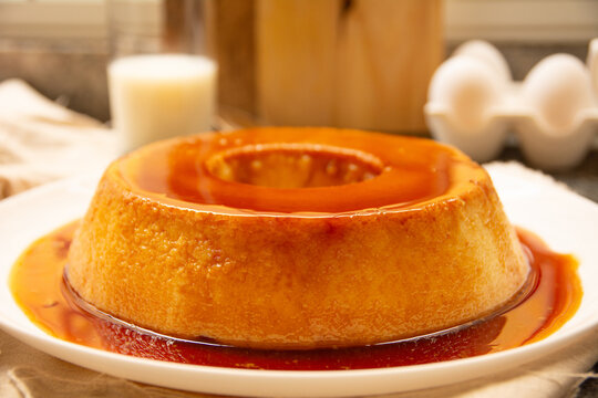 Creme Caramel Condensed Milk Pudim with melting caramel topping in front view