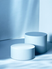 Pair of empty cylindrical pedestals, blue toned image. 3d computer graphic template of displaying place for your products.