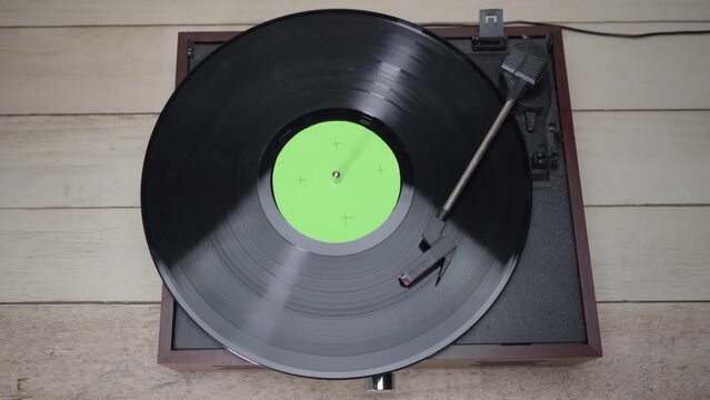 Vinyl Record Spinning with green screen croma on vinyl cover.