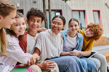positive african american woman holding hands with teen students, diversity, teacher, study