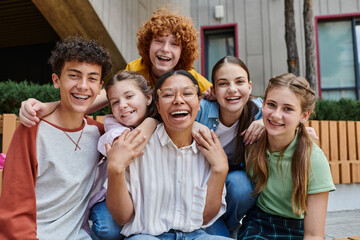 cultural diversity, back to school happy african american teacher hugging with teen kids, education
