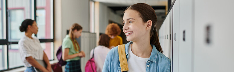 banner, happy teenage girl smiling in school hallway, cultural diversity, teacher and kids, blur