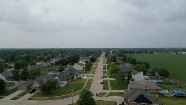This is a sliding shot from right to left over an Illinois residential neighborhood in a rural farm town on a cloudy day.