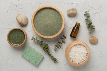 Composition with cosmetic clay and spa products on concrete background, top view