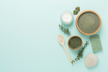 Composition with cosmetic clay and spa products on color background, top view