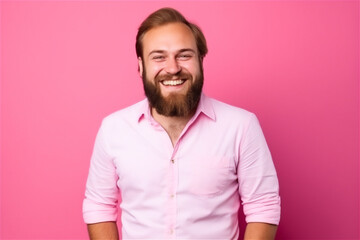 Fototapeta premium Caucasian young adult man smiling on a pink background