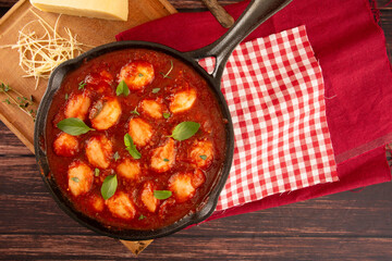 Delicious Gnocchi with Red Sauce and Basil in Iron Skillet