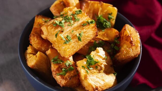 Fried Cassava in Handcrafted  Ceramic Bowl with fresh herbs in 