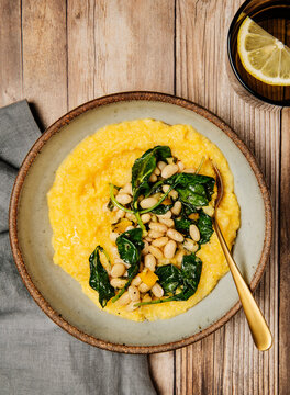 Bowl of polenta with white beans and spinach