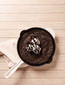 Pan of brownies with vanilla ice cream and hot fudge sauce