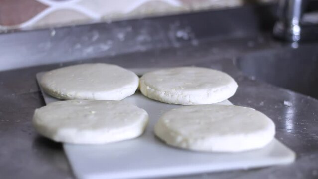 Colombian arepa prepared ready to cook on a stove in a kitchen